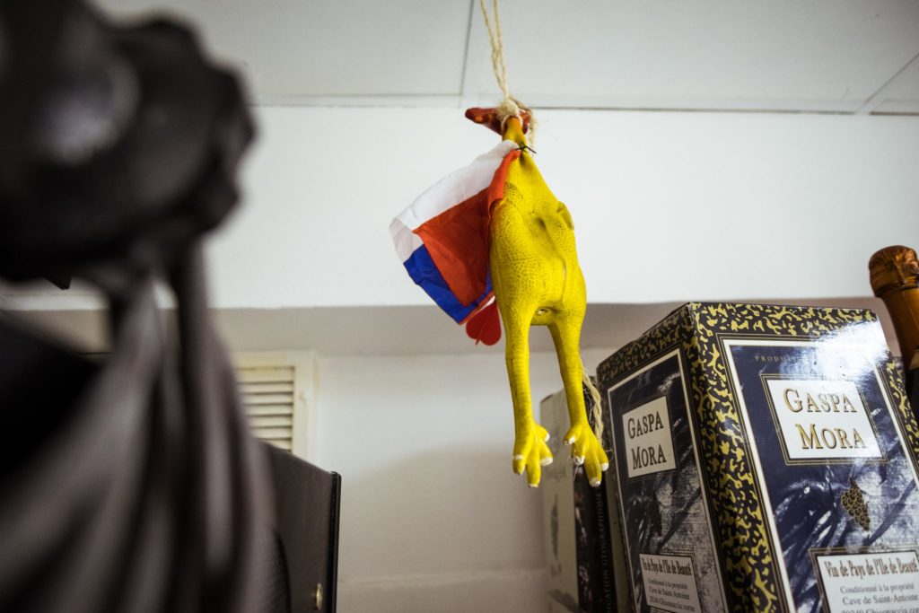 A toy chicken wrapped in a French flag hanging in the headquarters of Ghjuventù Paolina.